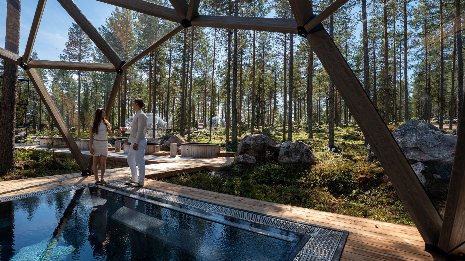 Couple by Blue Lagoon Pool in forest setting in Invisible Forest Lodge & Spa.