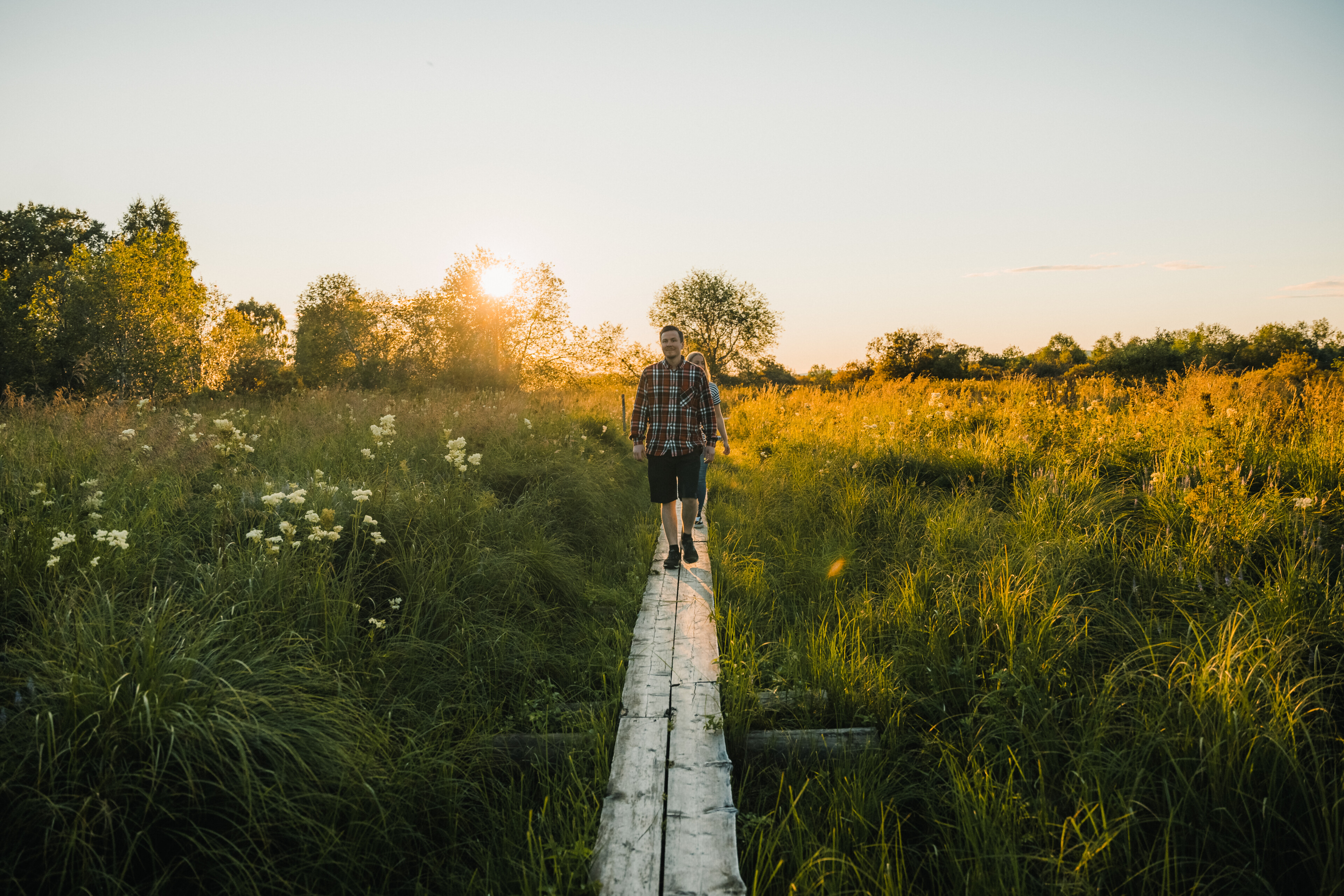 Couple walking in Koivusaari, Rovaniemi, Lapland, Finland, during summer and the midnight sun.