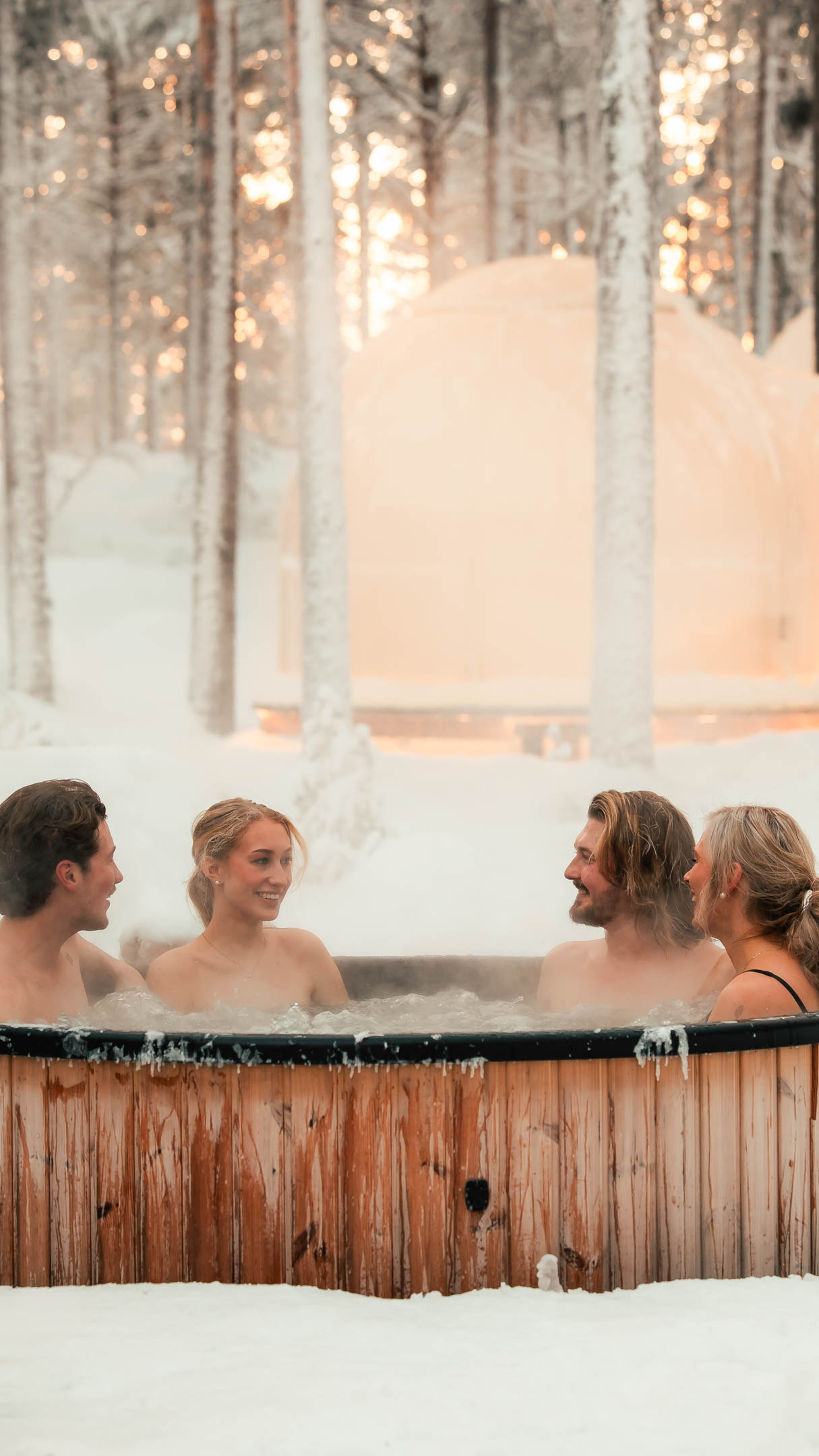 People enjoying hot tub in winter at Arctic Forest Spa, Invisible Forest Lodge.