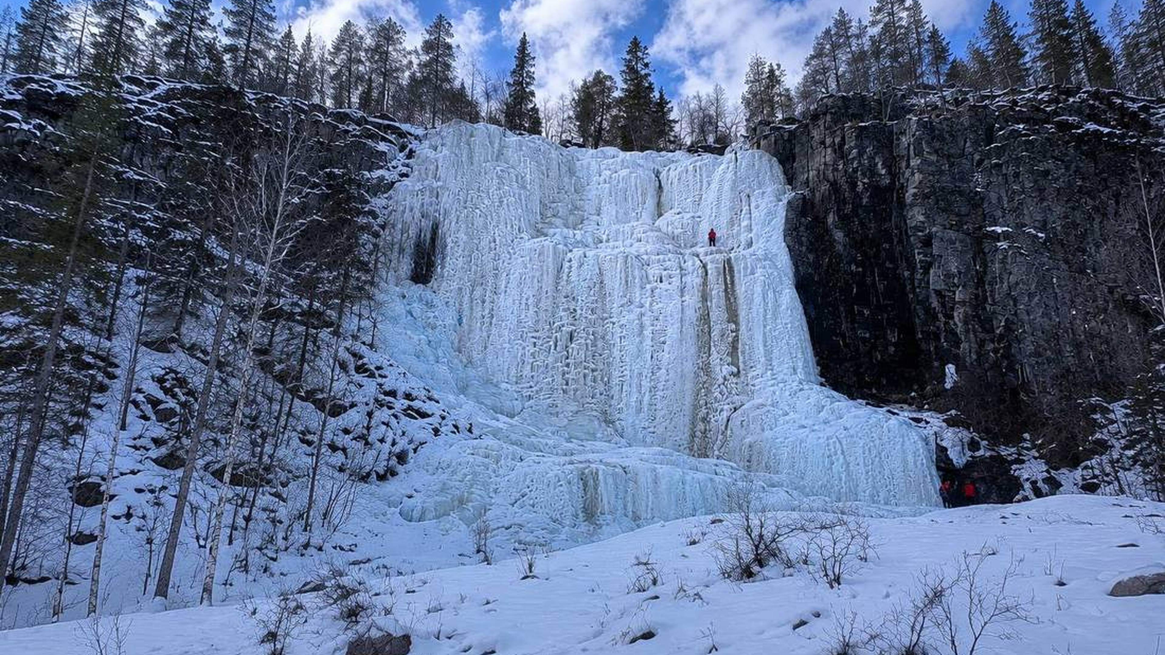 Frozen waterfalls surrounded by snow-covered landscape at Korouoma, Lapland, Finland.