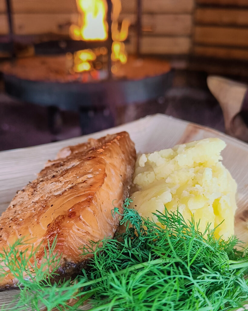 Lapland Food Like a Local Visit Rovaniemi preparing glow fried salmon.