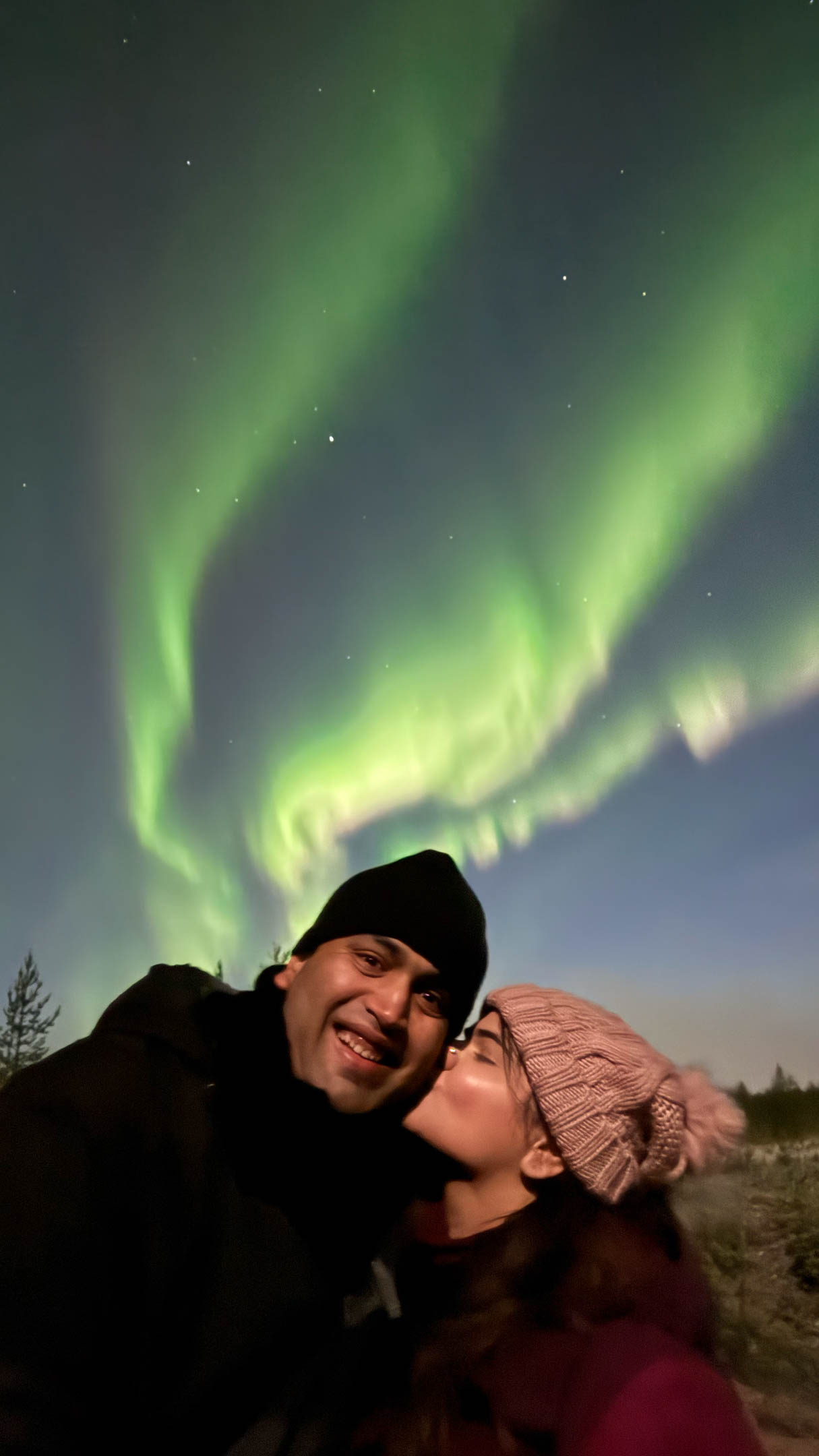 Couple under vibrant northern lights. Tour with Authentic Experiences, Rovaniemi, Lapland, Finland