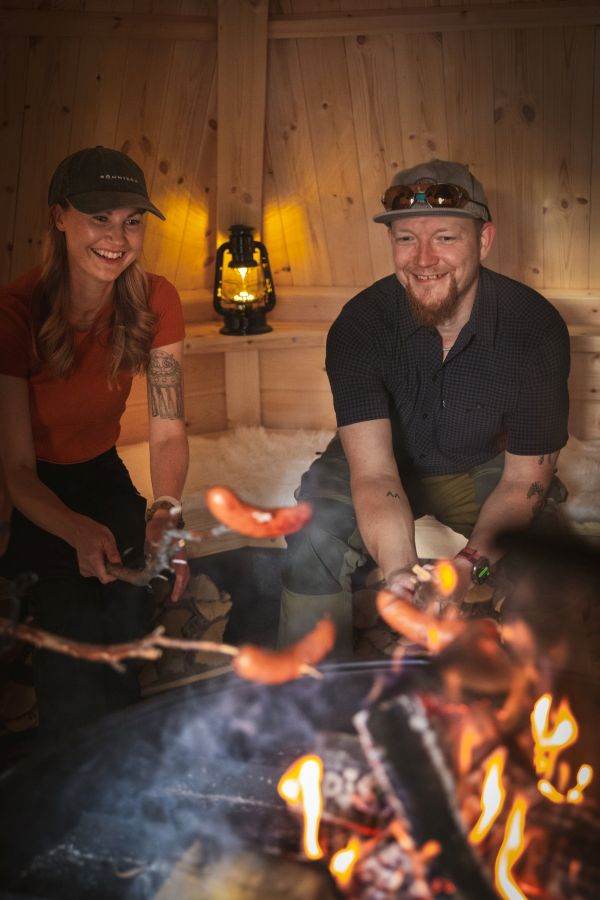 People smiling around bonfire