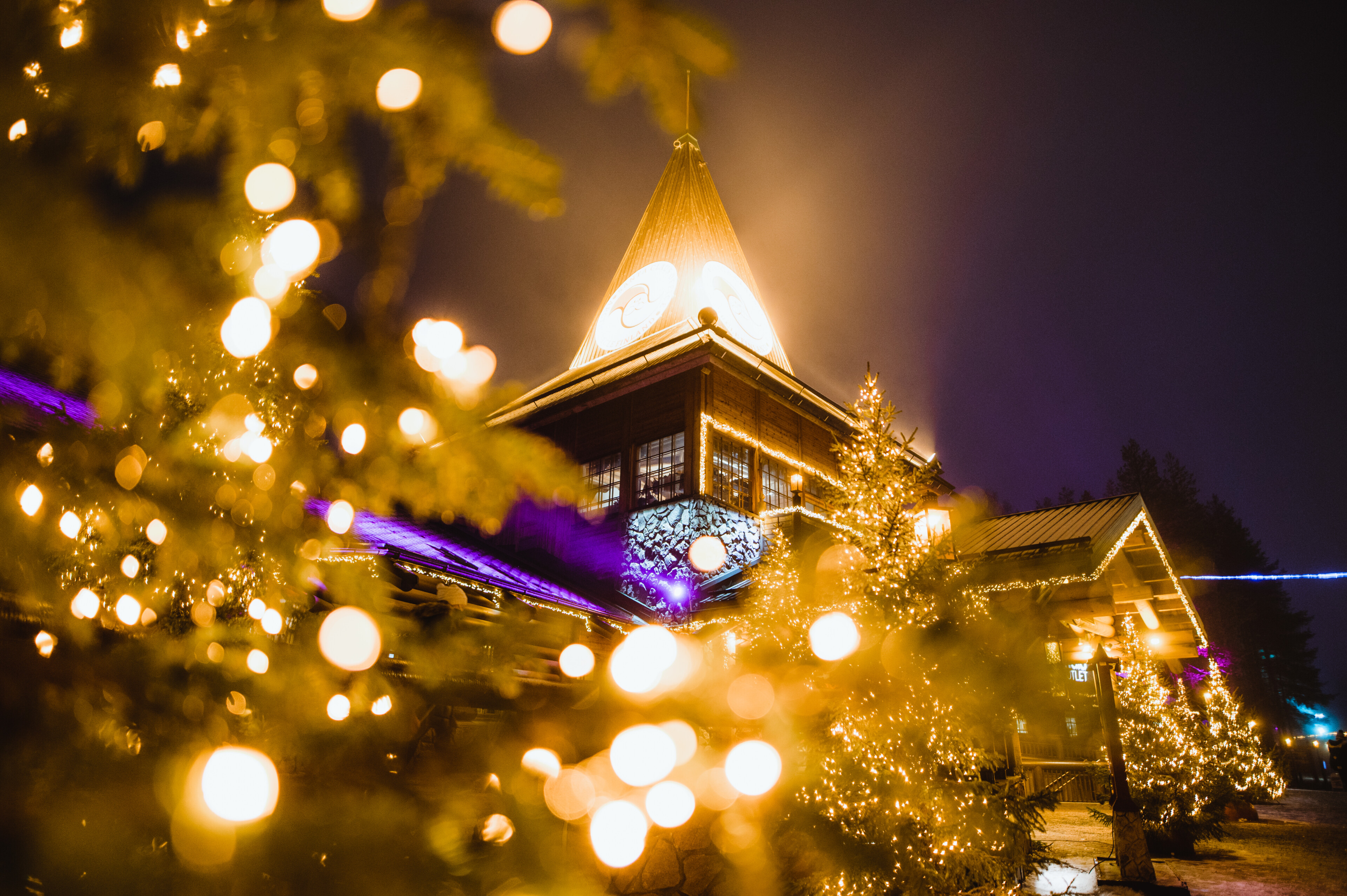 Santa Claus Village at the Arctic Circle with Christmas lights during winter with snow in Rovaniemi, Lapland, Finland.