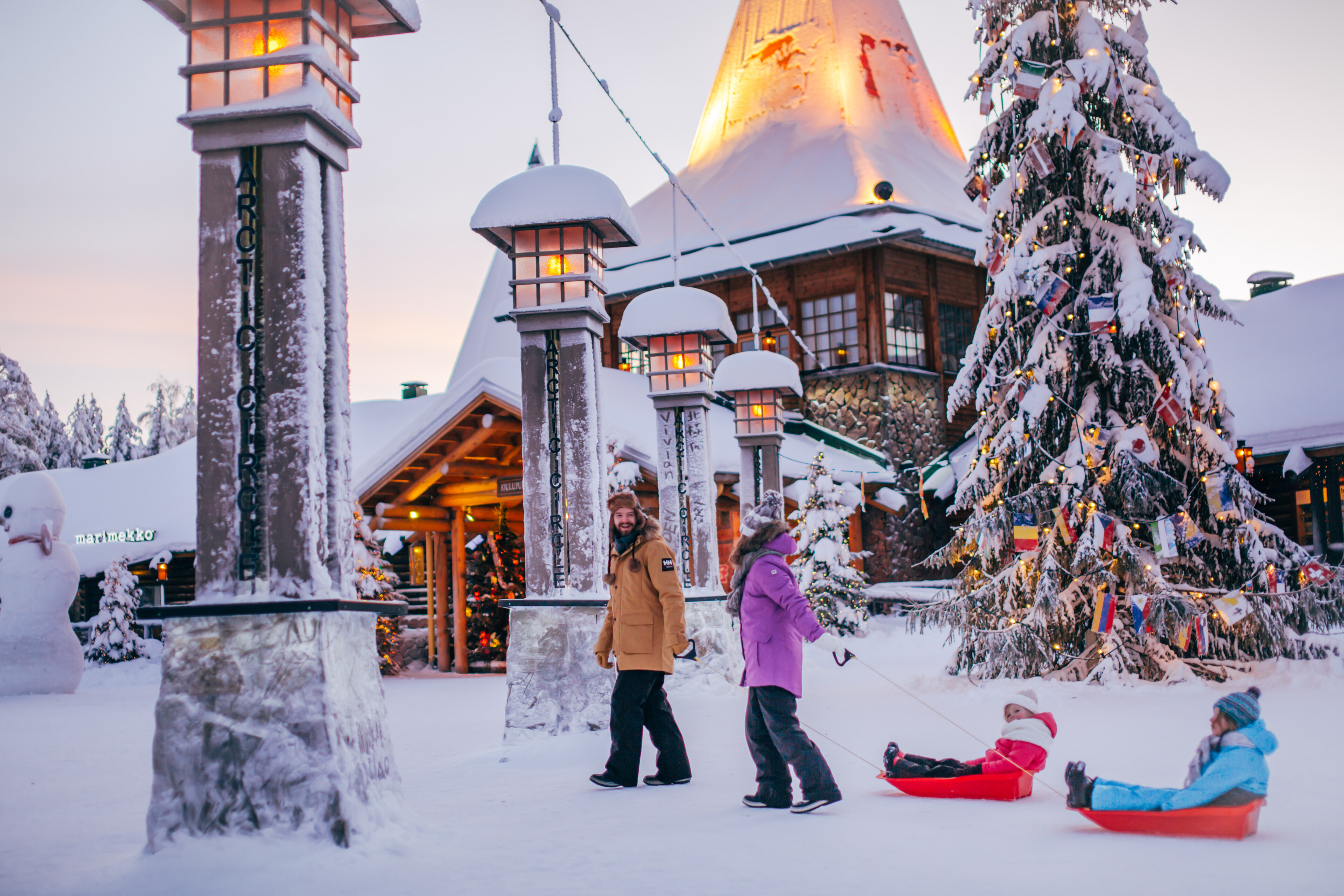 Santa Claus Village at the Arctic Circle with Christmas lights during winter with family and snow in Rovaniemi, Lapland, Finland.