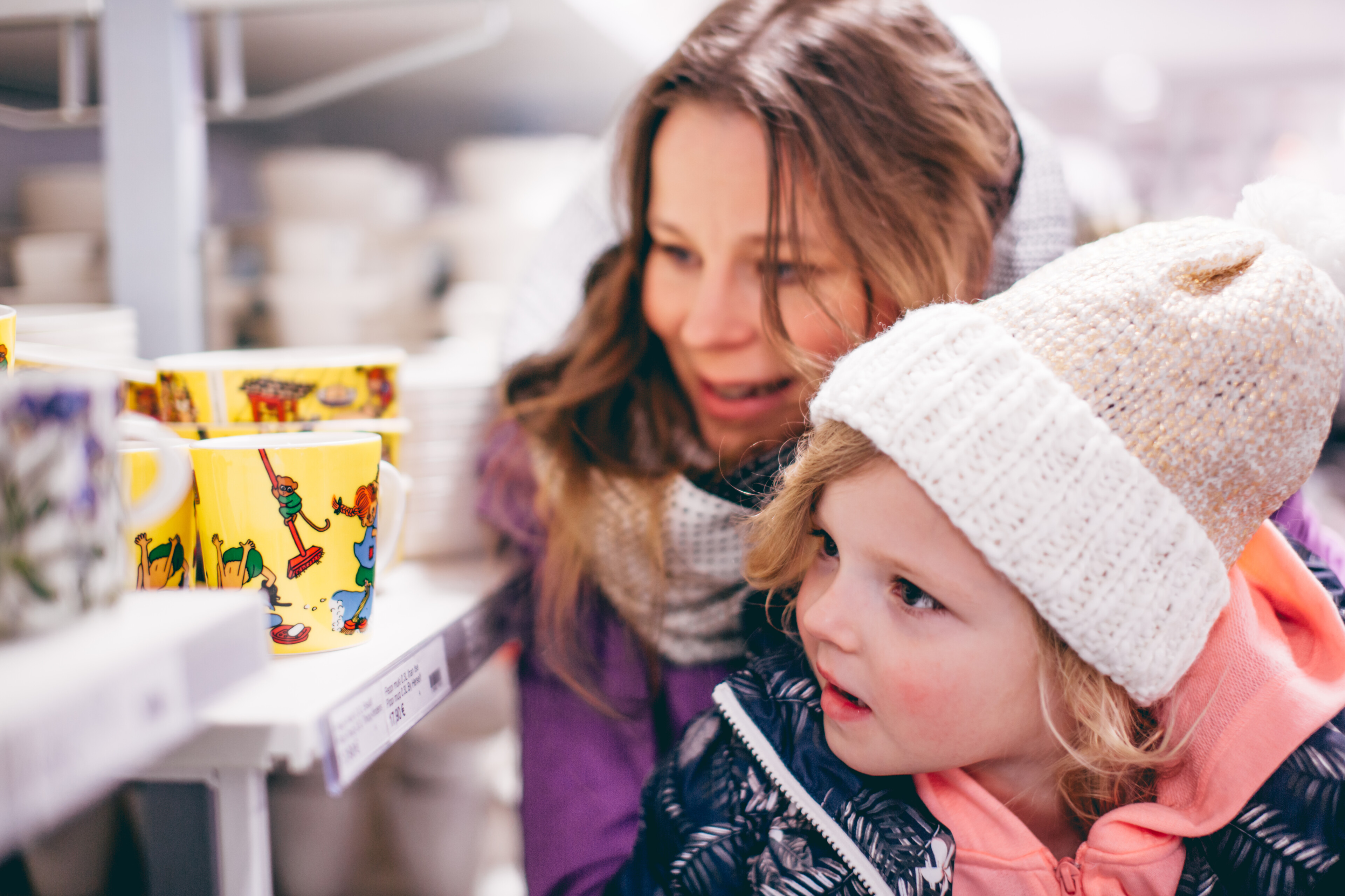 A child and a woman shopping together in Rovaniemi, Lapland, Finland with winter clothes on.