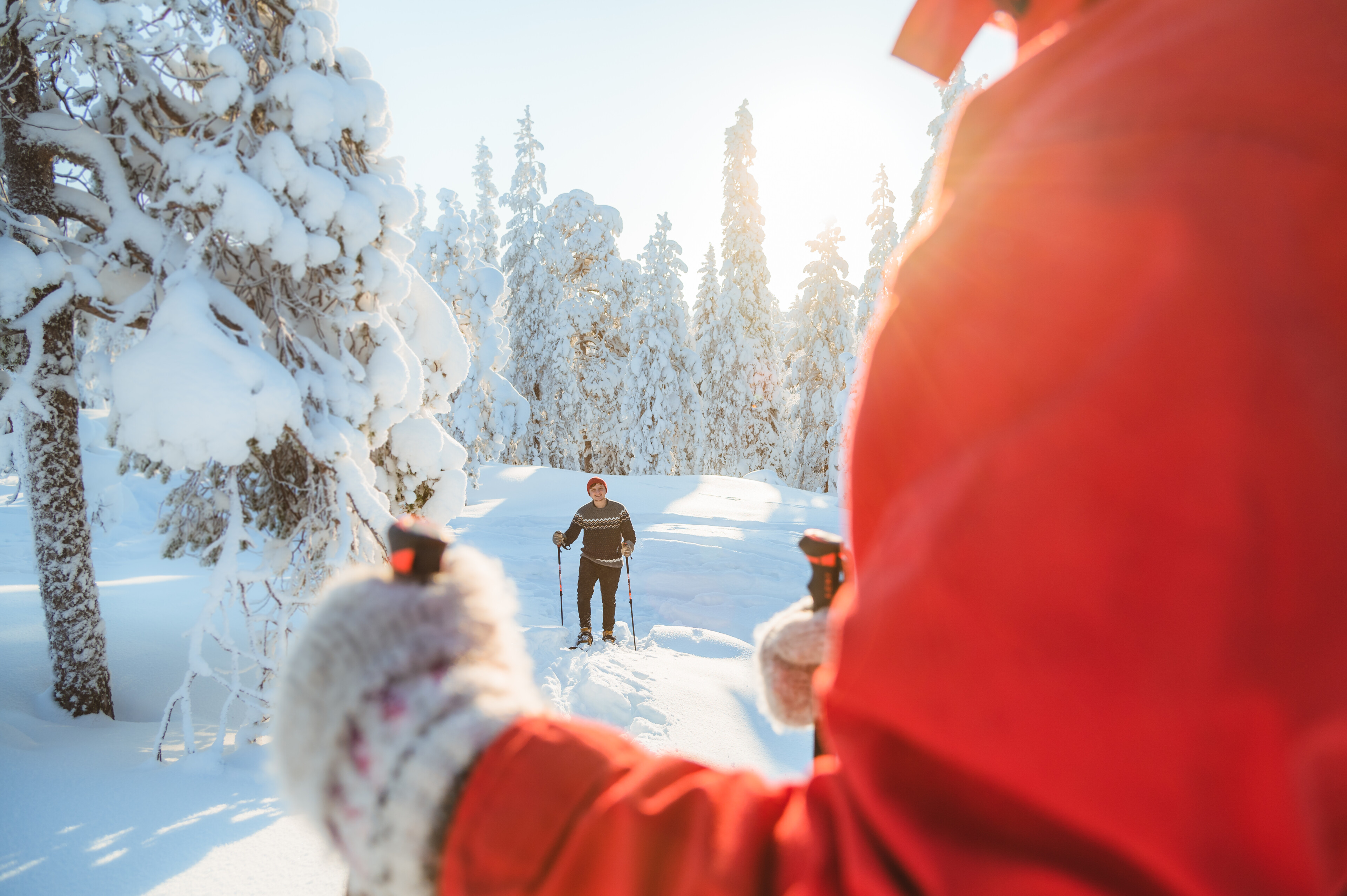 People enjoying winter, snow and sunshine with snowshoes in Rovaniemi, Lapland, Finland.
