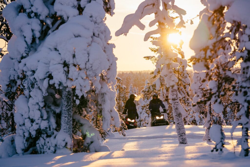 Snowmobile excursion in snowy winter forest, Rovaniemi, Lapland, Finland 