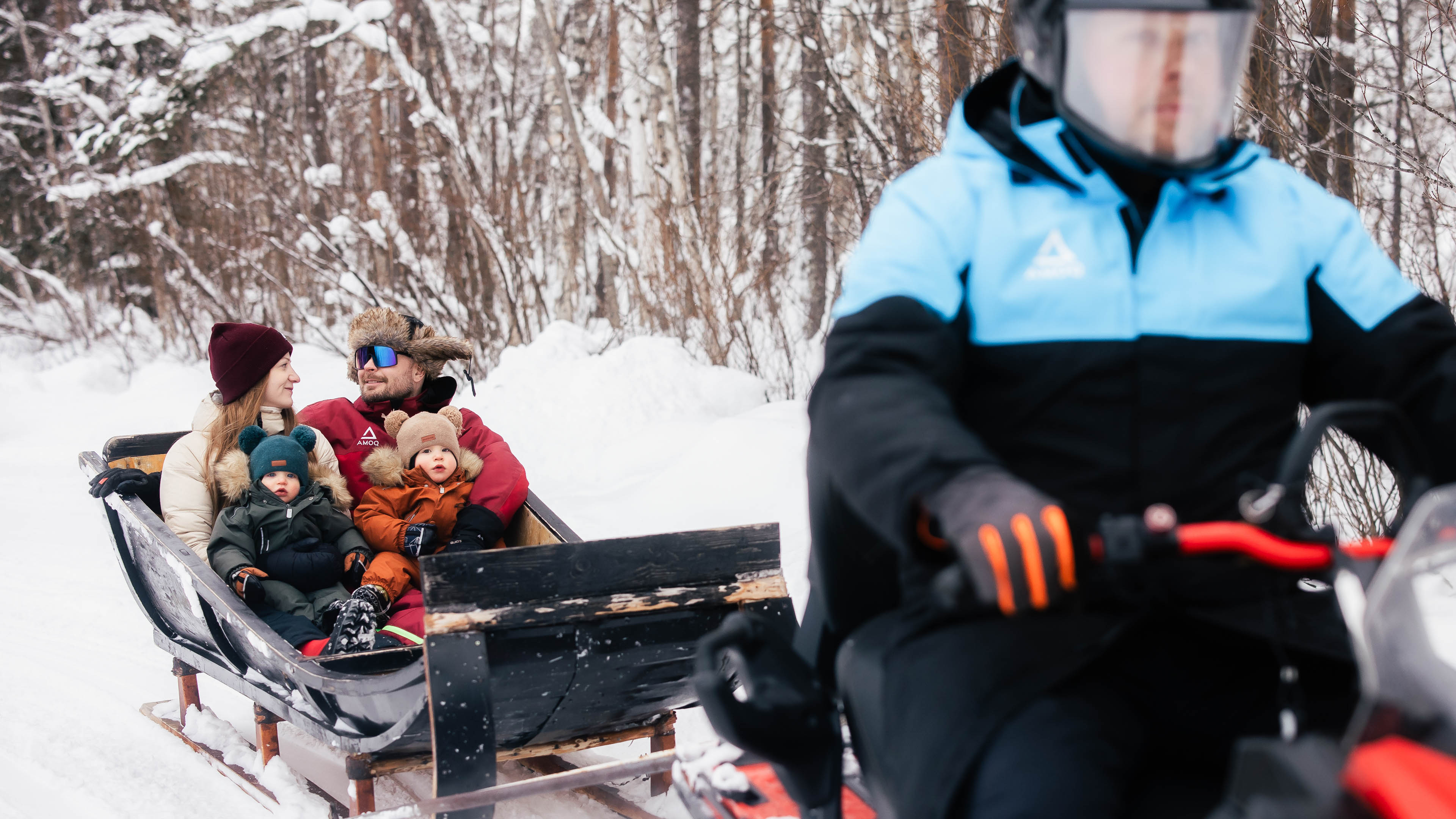 Family enjoying a winter sleigh ride at Arctic Park, Rovaniemi, Lapland, Finland