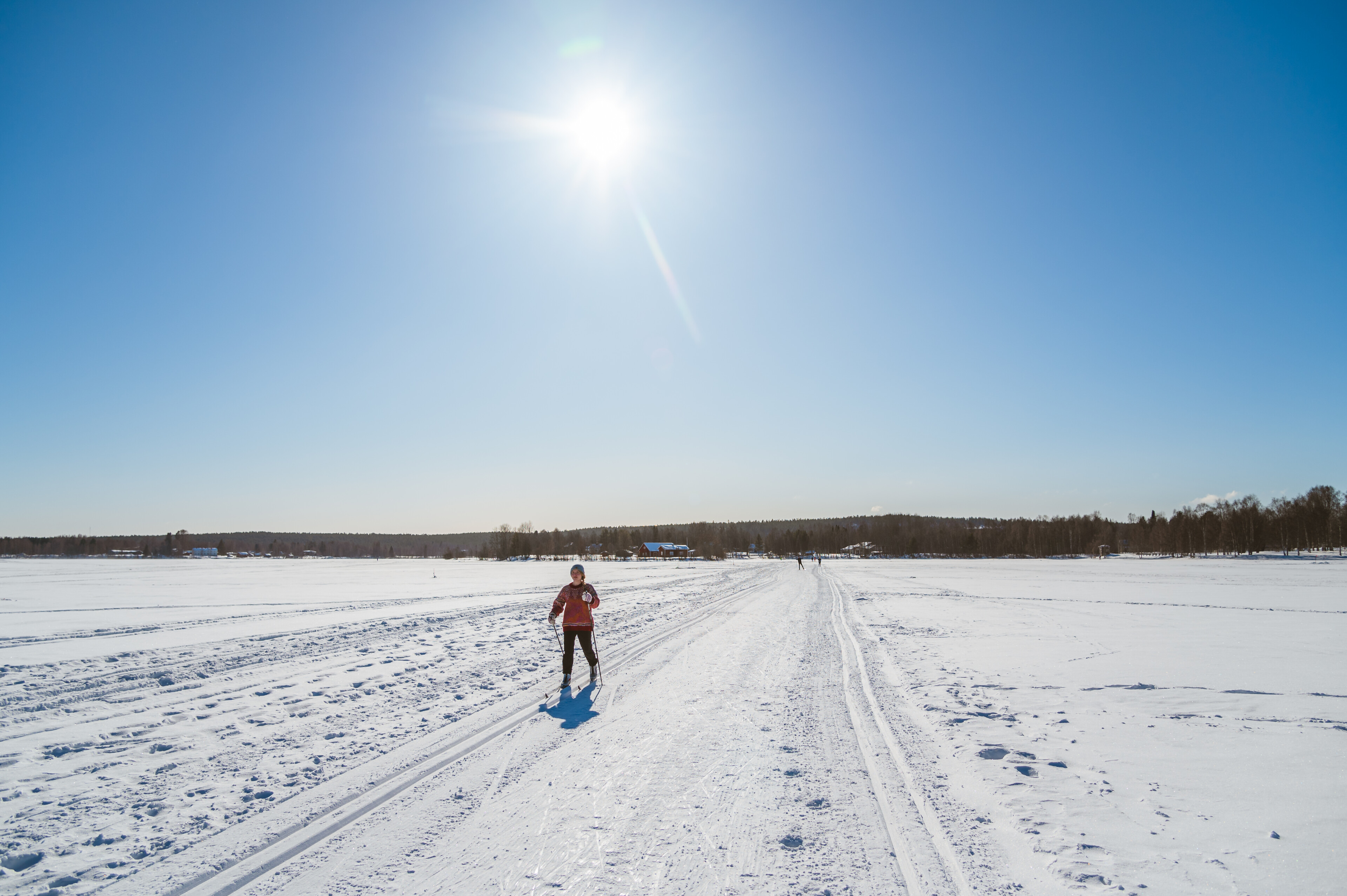 A woman skiing on ice during a sunny winter day in Rovaniemi, Lapland, Finland.