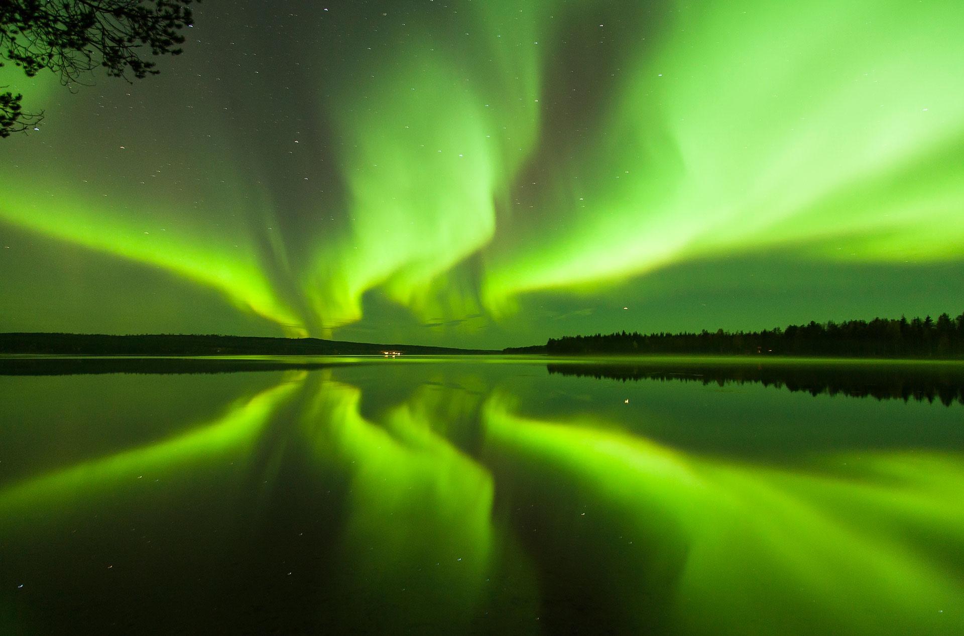 The Northern Lights reflected on a lake in Rovaniemi, Lapland, Finland